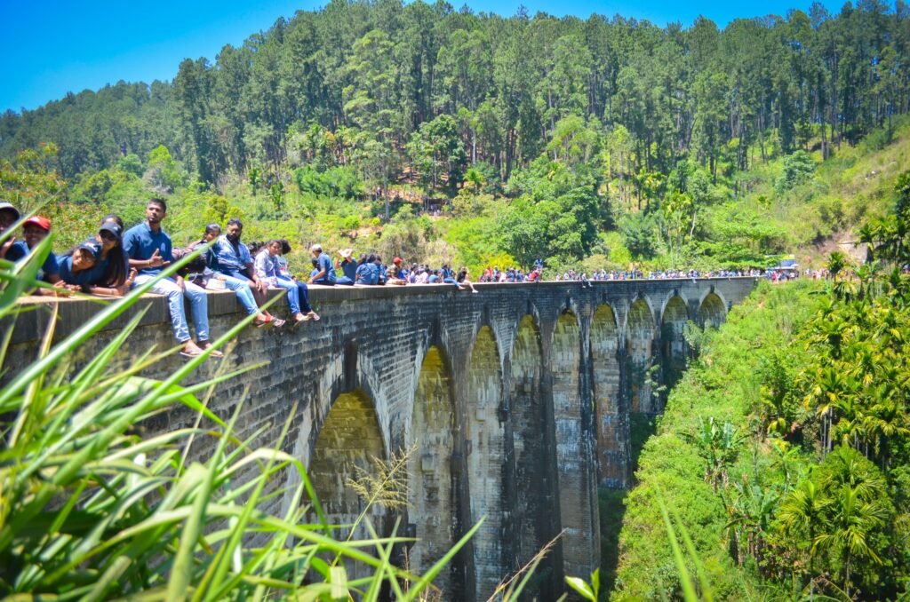 Visitors stroll along the Nine Arch Bridge, enjoying panoramic views of Ella’s breathtaking landscapes.